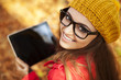 © gpointstudio - Smiling young woman using digital tablet