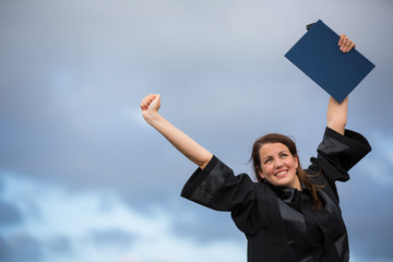 Pretty, young woman celebrating joyfully her graduation