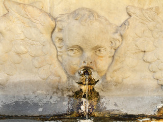 old public drink water source with angelic decoration