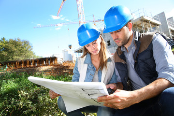 Construction engineers working together on site