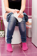 © Nobilior - Woman in a toilet with a sanitary napkin