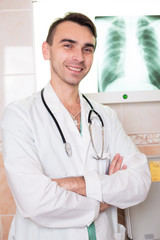 Зortrait of male doctor in a clinic with a stethoscope smiling