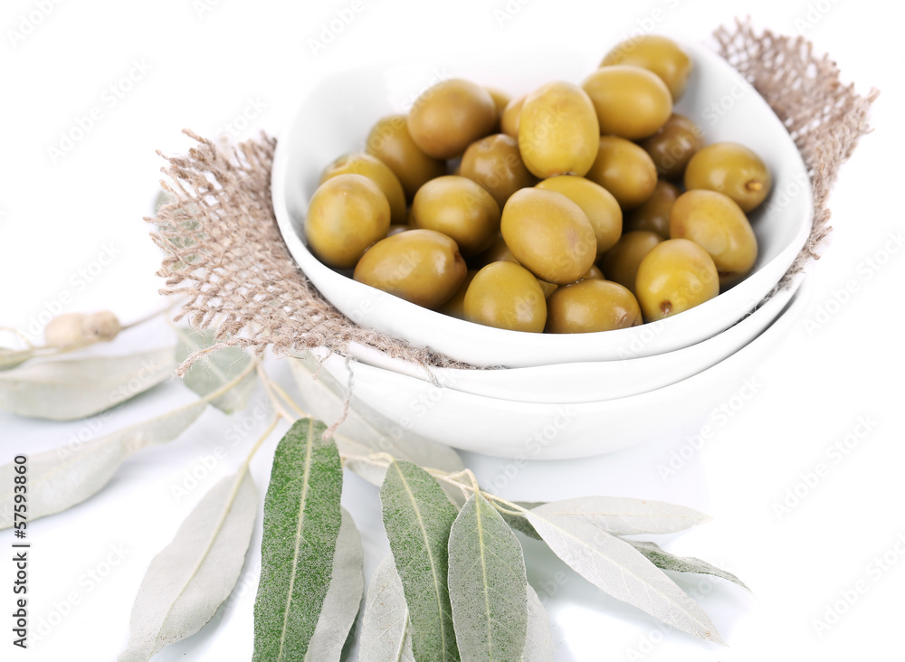Olives in bowl with branch isolated on white