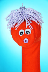 Wall Mural - Cute sock puppet on blue background