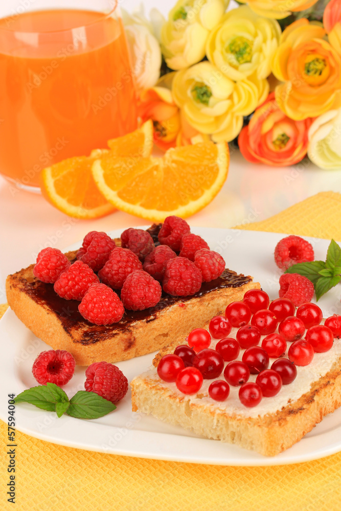 Delicious toast with berries on table close-up