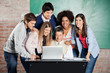 © Tyler Olson - Students Standing With Classmates While Teacher Teaching On Lapt