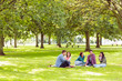 © WavebreakMediaMicro - College students sitting on grass in park