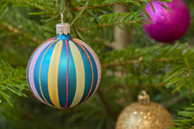 Christmas Tree Ball In Front Of Green Branches