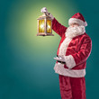 Santa Claus with a lantern on a turquoise background