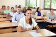 © luckybusiness - Students sitting at the classroom