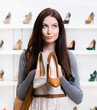 © Karramba Production - Girl keeps two shoes in the shopping mall
