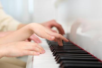 Close up of hands playing piano