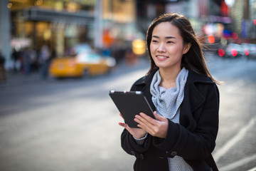 Sticker - Asian woman in New York City using ipad tablet pc