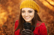 © gpointstudio - Beautiful young woman drinking hot drink in park