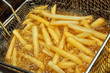 French fries in a deep fryer closeup