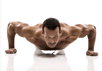 Muscle man in studio and showing the biceps muscle