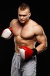 © Nejron Photo - Handsome muscular young man wearing boxing gloves