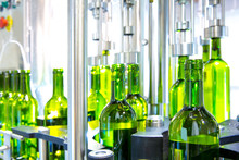 White Wine In Bottling Machine At Winery