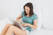 © lightwavemedia - Casual woman using laptop in bed