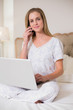 © lightwavemedia - Natural happy woman using laptop and phoning