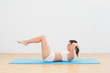 © lightwavemedia - Side view of a sporty woman doing sits up