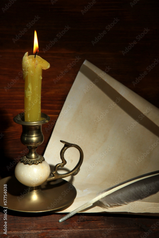 Old candle on table in room