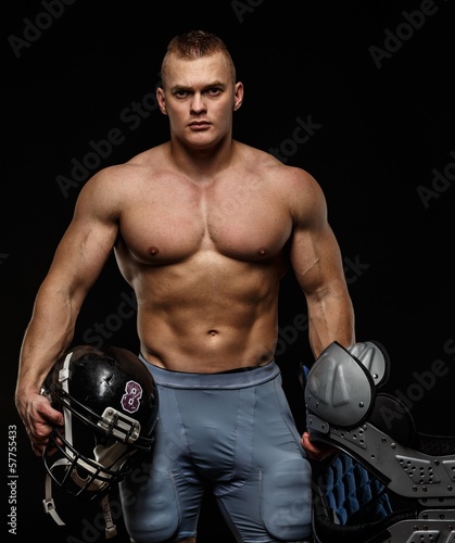 Foto-Stoff bedruckt - Man holding american football player accessories (von Nejron Photo)