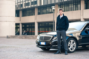 Young elegant man portrait with luxury car.