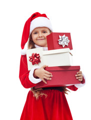 Little girl in santa costume holding presents