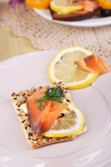 Sticker - Salmon sandwiches on plate  on wooden table close-up