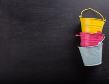 Small Decorative Buckets On Wooden Background