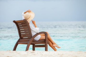 Wall Mural - Pretty woman relaxing on the beach