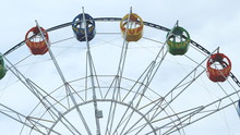 Underside View Of A Ferris Wheel Over Blue Sky