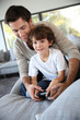 © goodluz - Daddy with kid playing video game