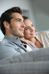 Fototapete - Couple at home relaxing in sofa