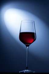 red wine in glass on blue