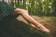 © Wavebreak Media - Legs of a woman wearing a dotted skirt sitting on tree