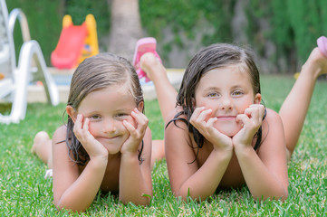 little girls lying in garden