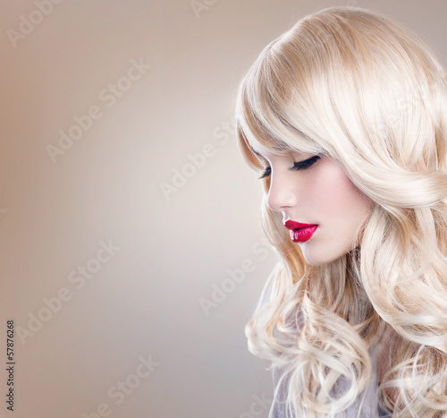 Fototapeta na wymiar Blonde Woman Portrait. Beautiful Blond Girl with Long Wavy Hair