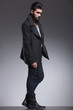 © Viorel Sima - young bearded fashion man in a long coat looking away