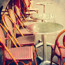 Tables And Chairs At Street Cafe In Paris, France