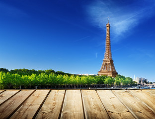 Wall Mural - background with wooden deck table and Eiffel tower in Paris