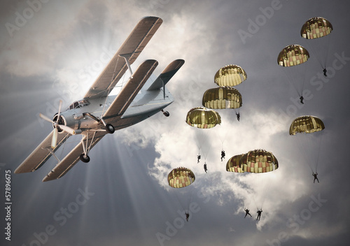 Tapeta ścienna na wymiar Retro style picture of the biplanes with sky divers.