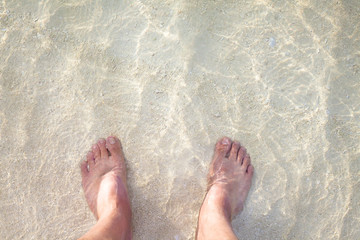 foot on the sandy beach