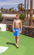 © travelview - walking boy in a pool area