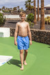 © travelview - walking boy in a pool area