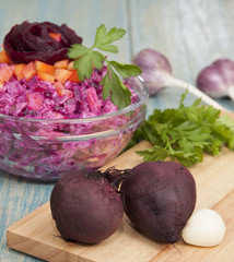 Two boiled beets and beet salad with bell pepper, rice, garlic a