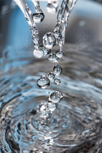 Obraz w ramie Splashed water drops. Fresh, blue water. Natural background.
