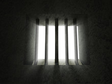 Old Grunge Prison With Sun Rays Breaking Through A Barred Window