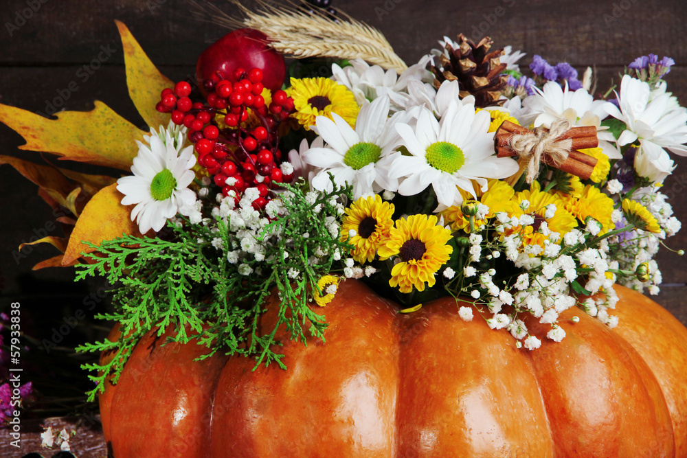 Beautiful autumn composition in pumpkin on wooden background
